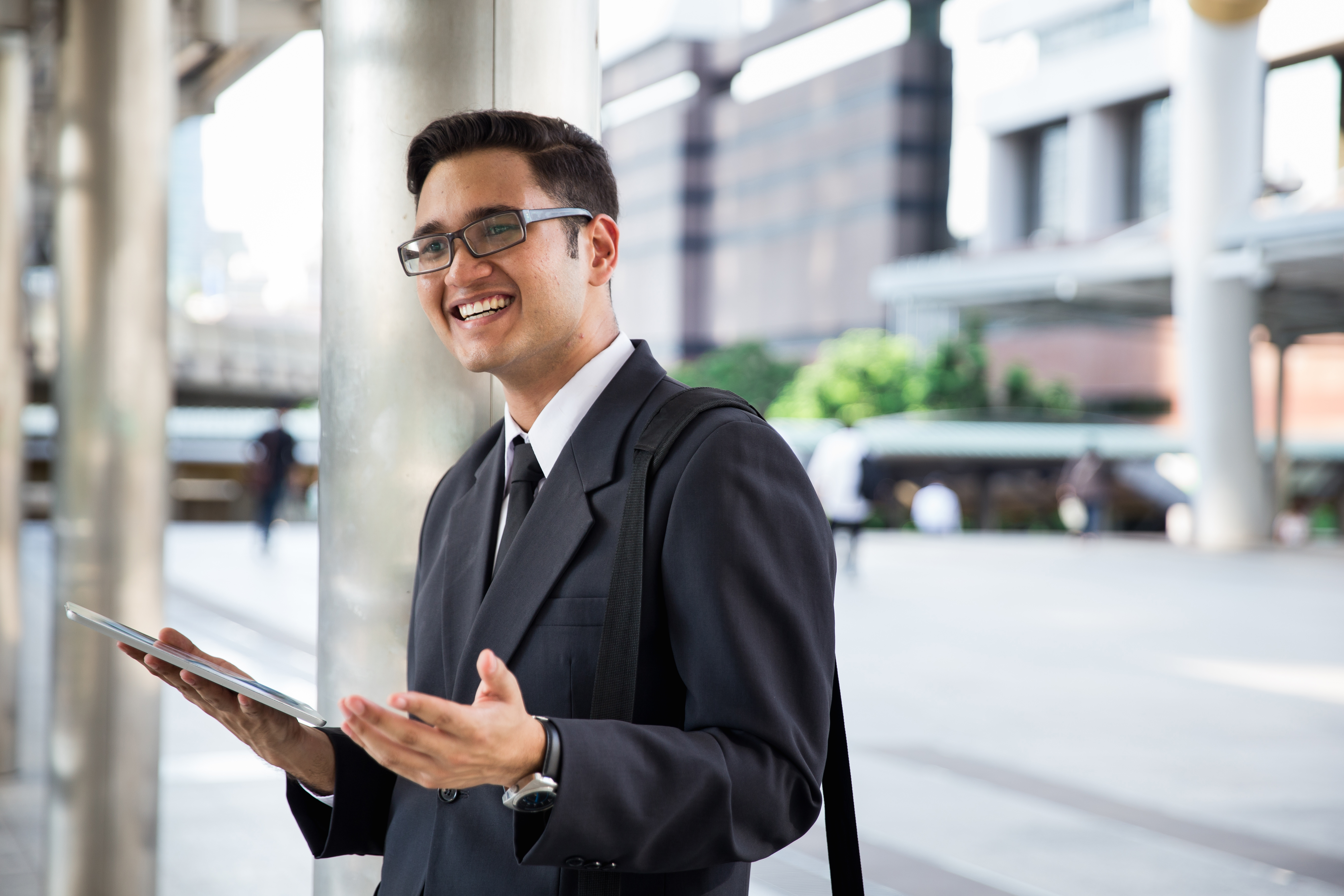 a male expert in finance holding a tablet