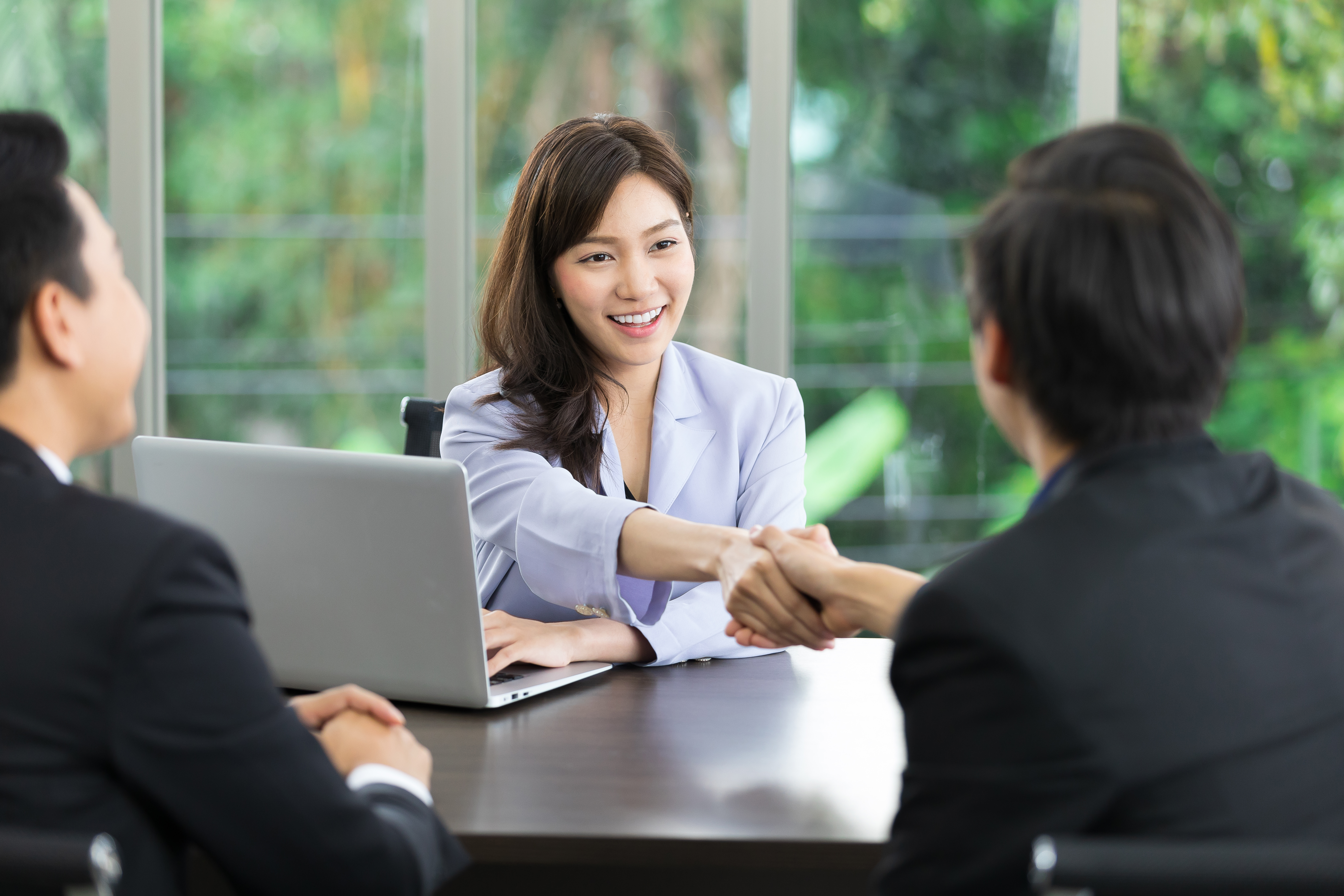 a finance expert shaking hands with a client